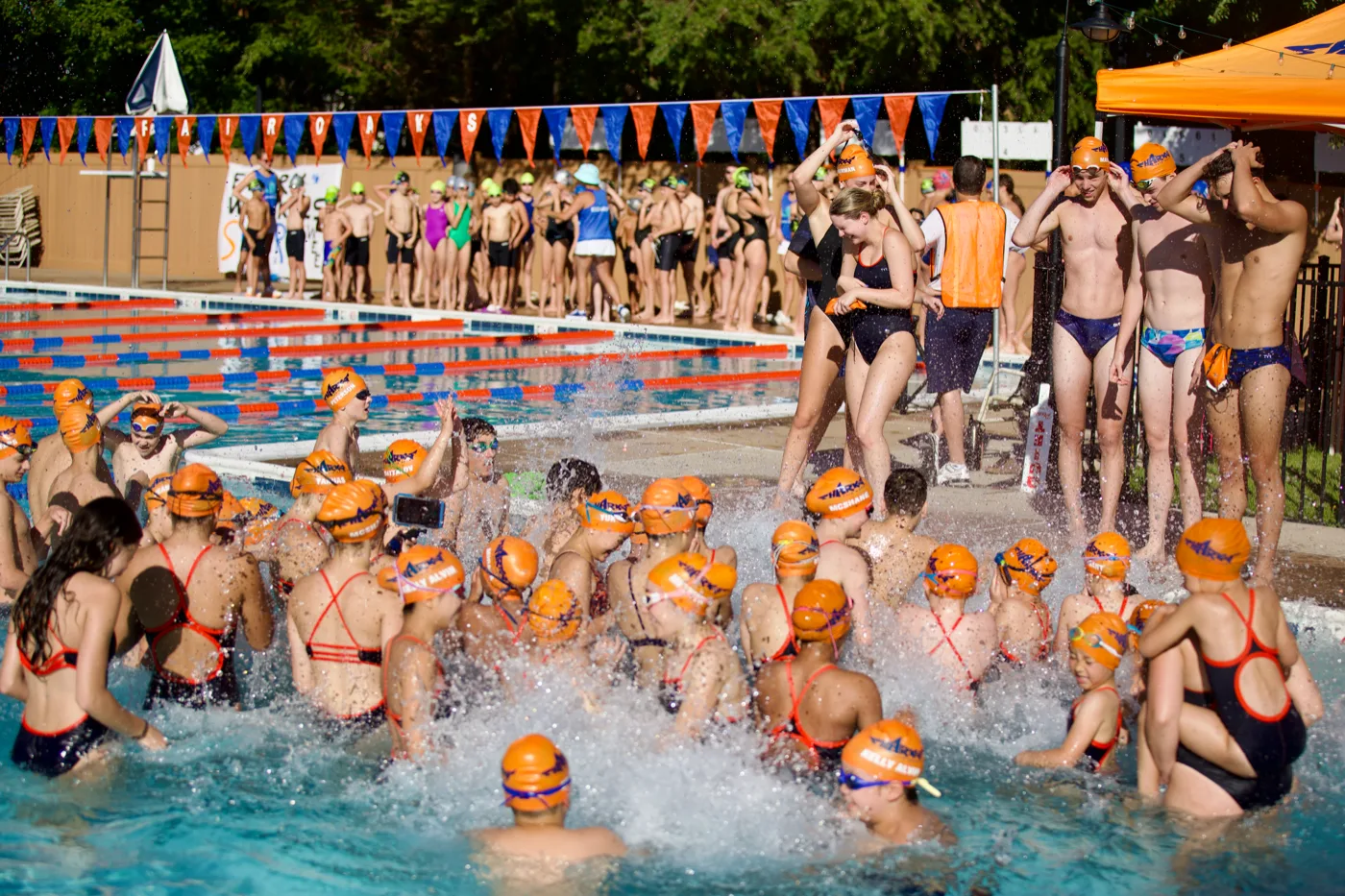 Swim team splashing together in the pool
